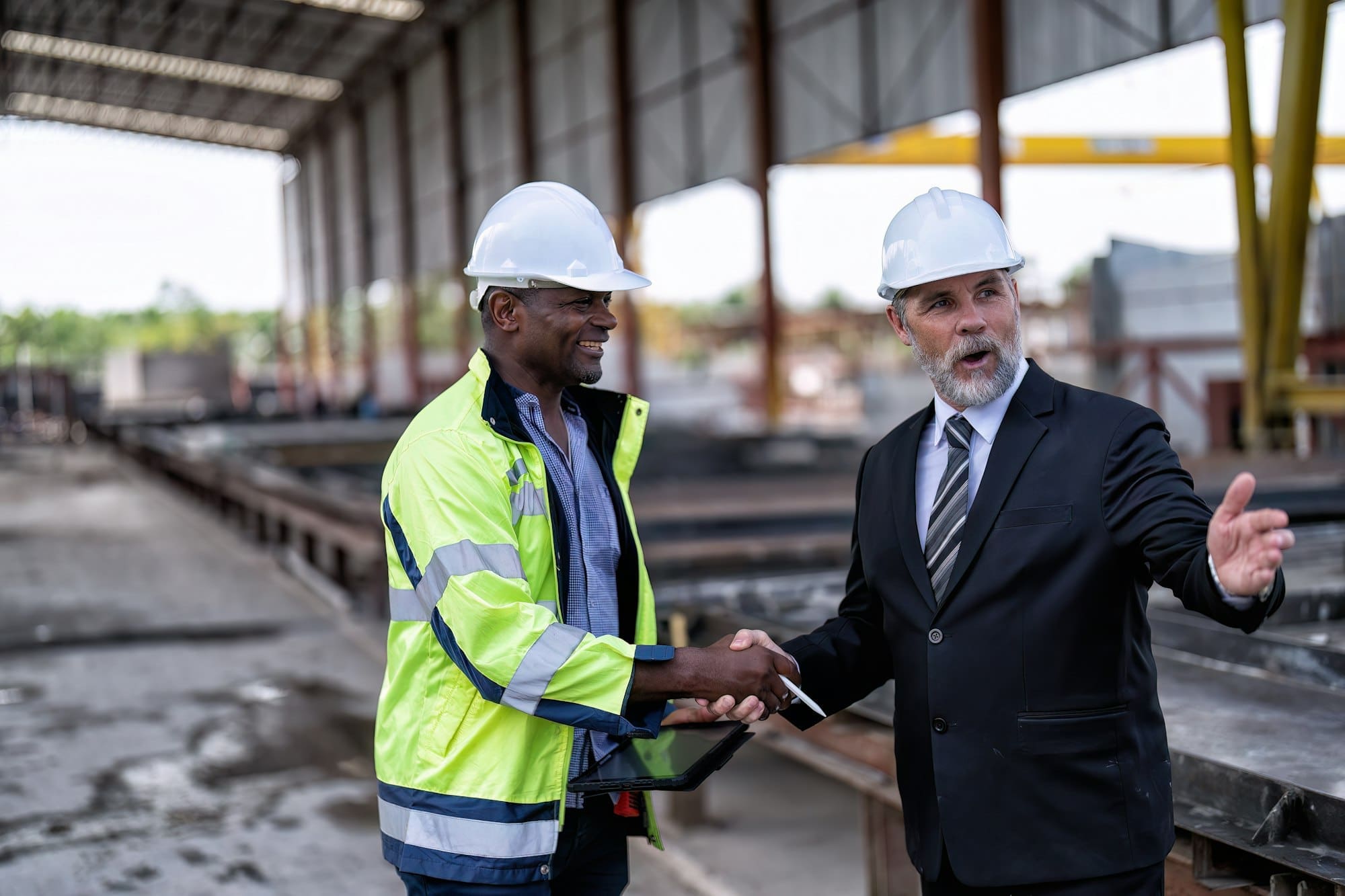 At construction site manager meet engineer check precast concrete slabs and smiling check hand