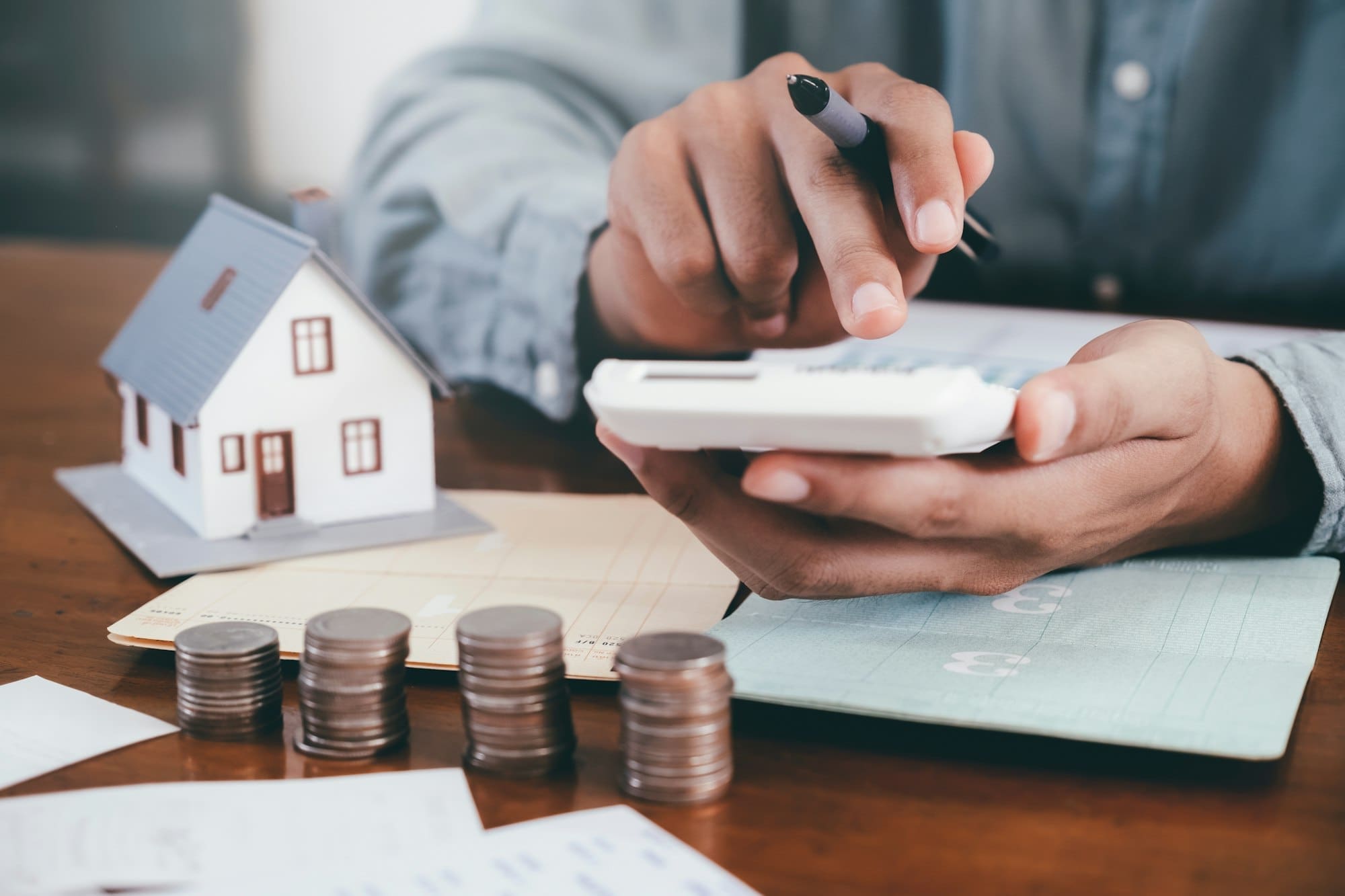 Businessman is Savings money and calculating.Save money for home cost