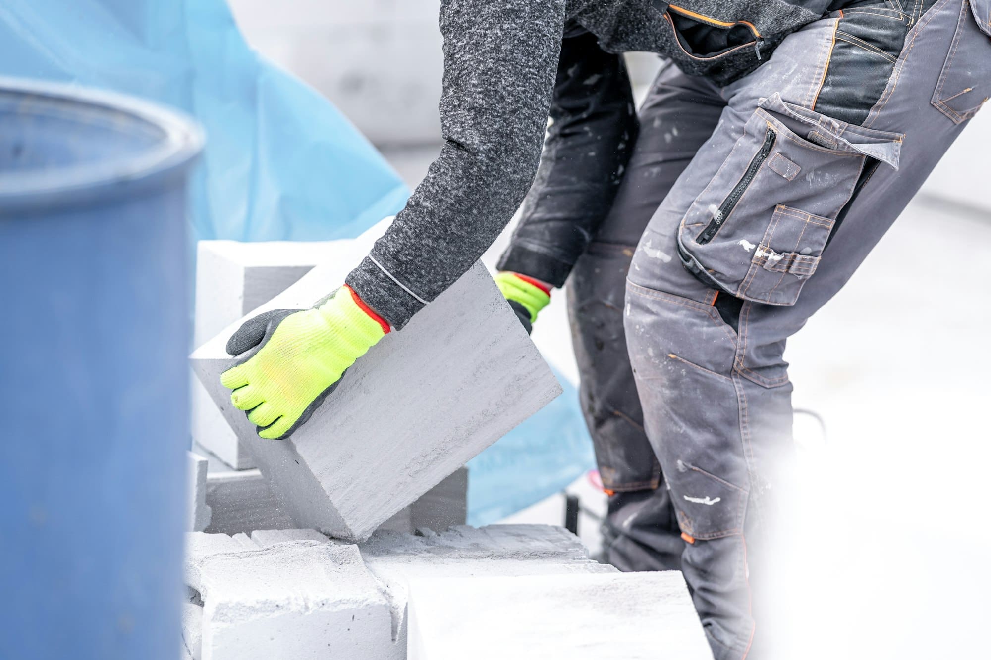 craftsman builds a house from concrete bricks