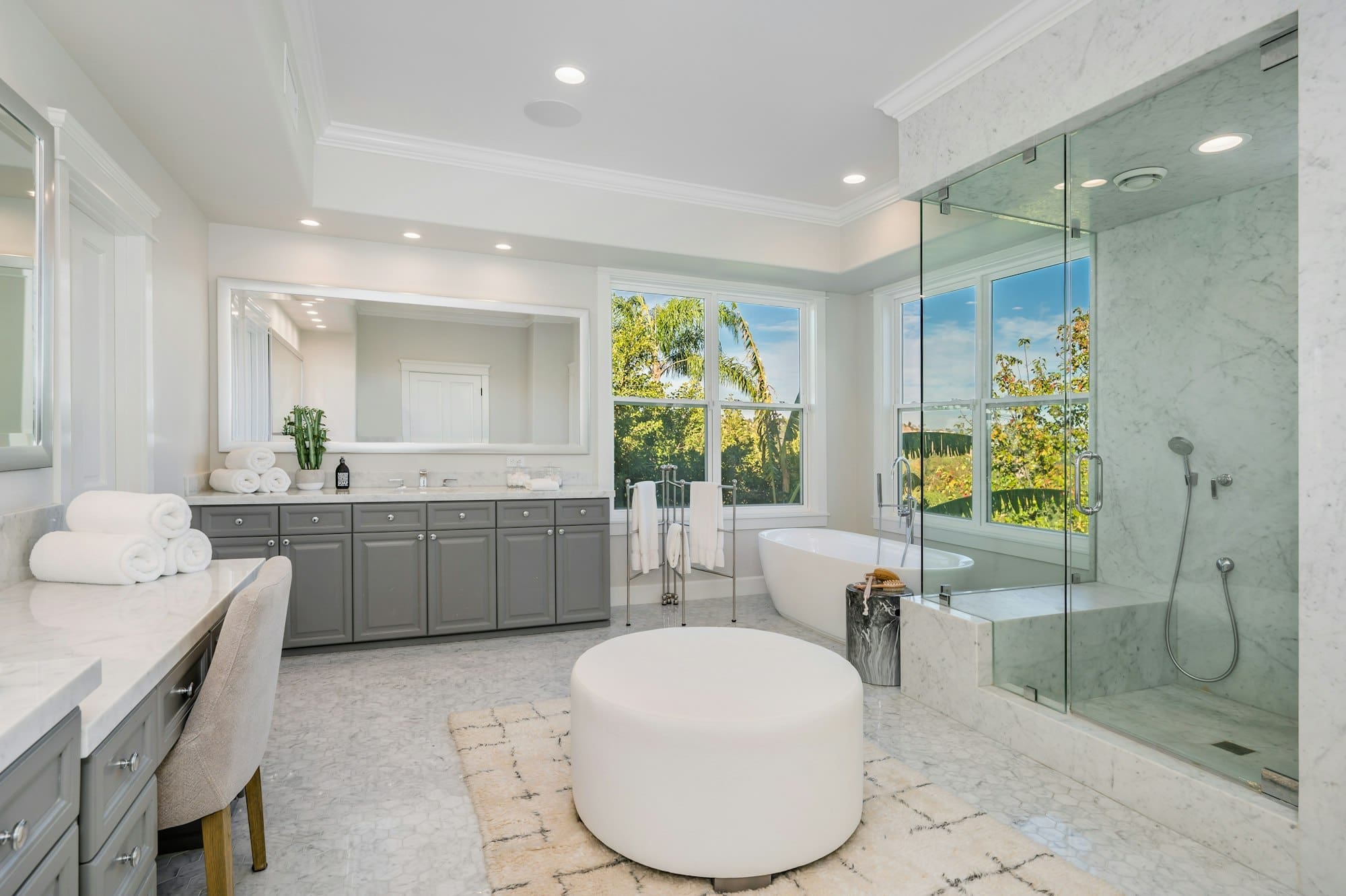 Modern bathroom featuring a walk-in shower, bathtub, and a window view
